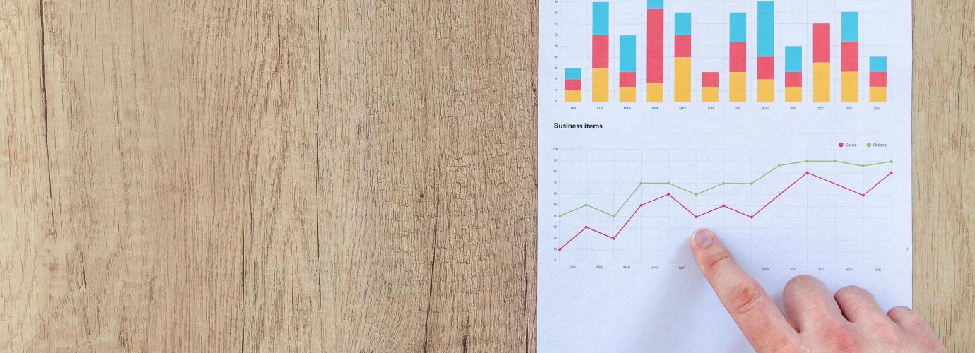 Person pointing at graph in an evaluation chart