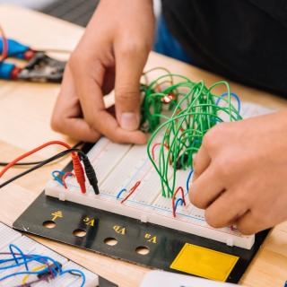 person working on a circuit board