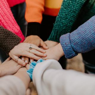 people putting hands together