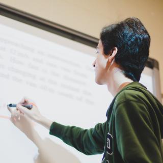 boy writing on a digital whiteboard