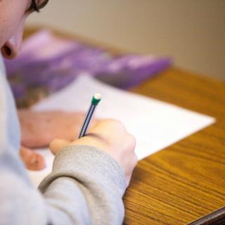 boy writing on paper boy writing on paper