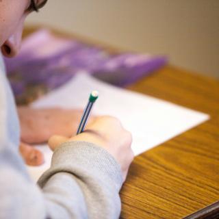 boy writing on paper