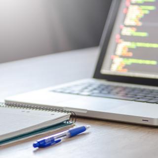 laptop with notebook and pen laptop with notebook and pen