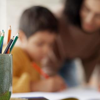 Teacher supporting child in classroom