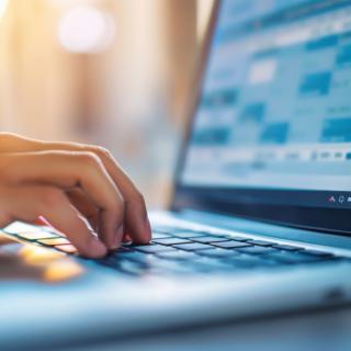 Person typing on laptop Person typing on laptop