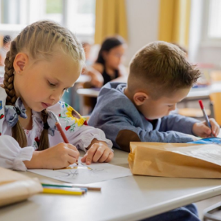 Children in class taking notes Children in class taking notes