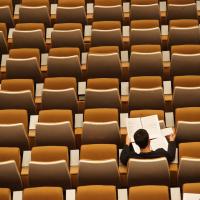 student sitting alone in an auditorium