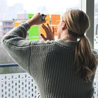 woman writing on sticky notes